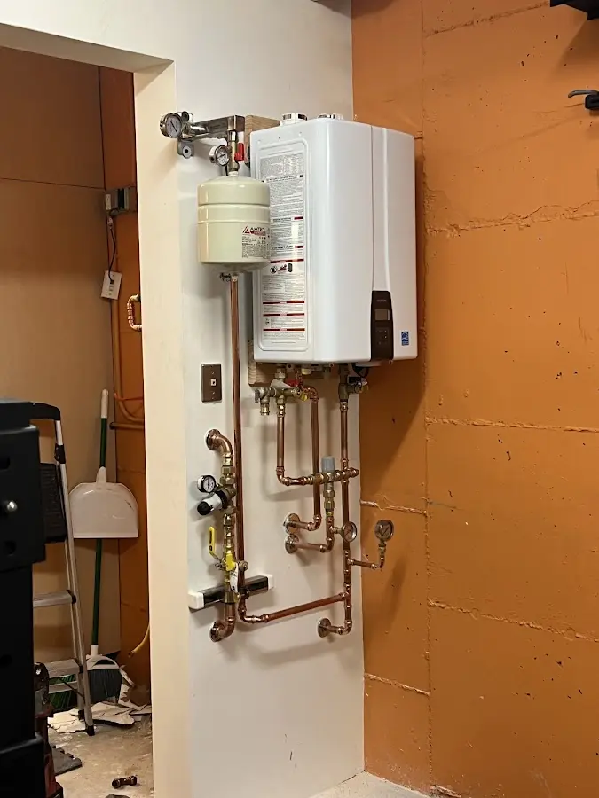 Plumbing technician inspecting water heater connections in Tybee Island